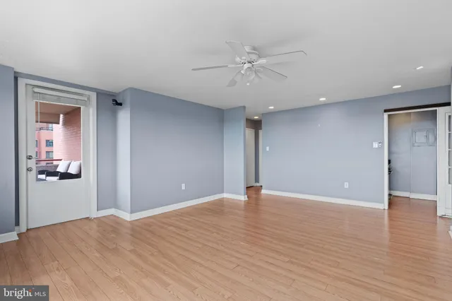 a view of an empty room with wooden floor