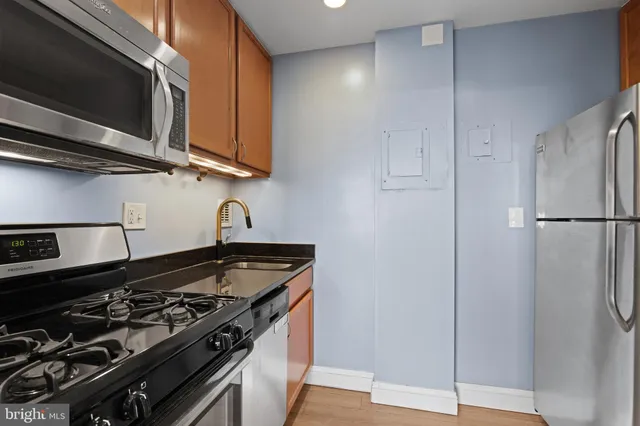 a kitchen with stainless steel appliances granite countertop a stove and a microwave