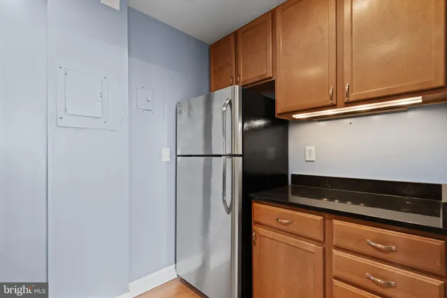 a kitchen with a refrigerator and cabinets