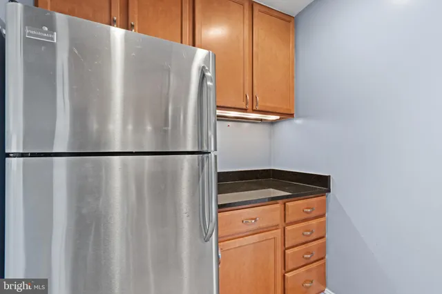 a kitchen with a refrigerator and cabinets