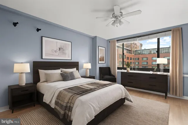 a bedroom with a large bed and a lamp