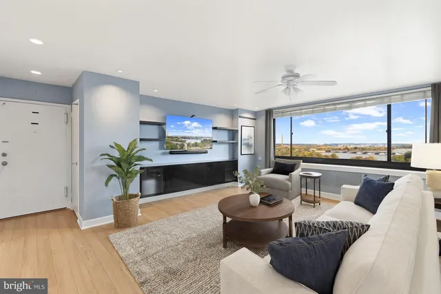 a living room with furniture and a large window