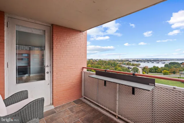 a view of a balcony with furniture and city view