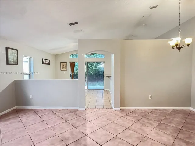 a view of a room with window and hardwood