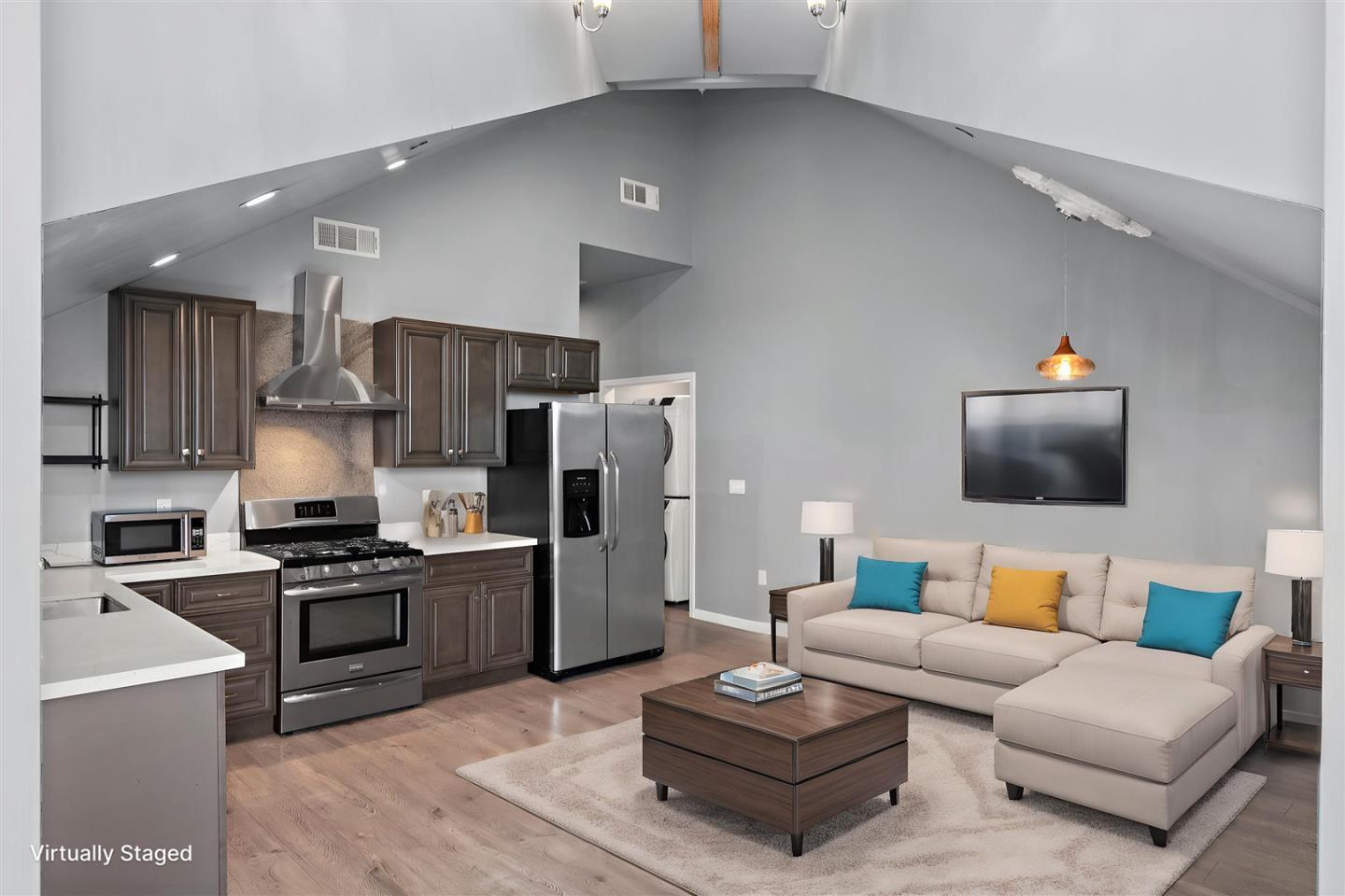 350 4th Street Oakland, CA 94607 - Photo 3 of 13 a living room with furniture and a flat screen tv