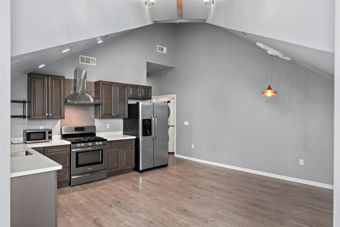 350 4th Street Oakland, CA 94607 - Photo 4 of 13 a kitchen with stainless steel appliances a refrigerator a stove top oven a sink and dishwasher
