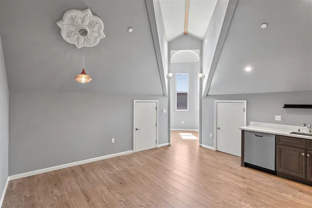 a view of a kitchen with a sink cabinets and wooden floor