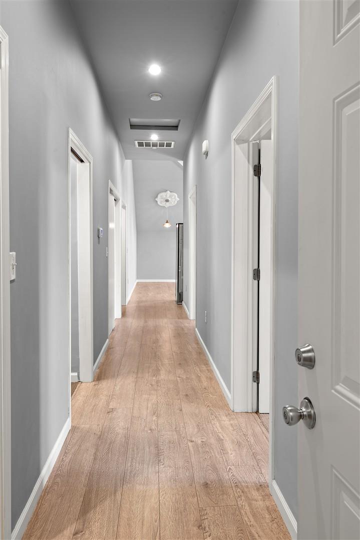 350 4th Street Oakland, CA 94607 - Photo 10 of 13 a view of a hallway with wooden floor and a bathroom