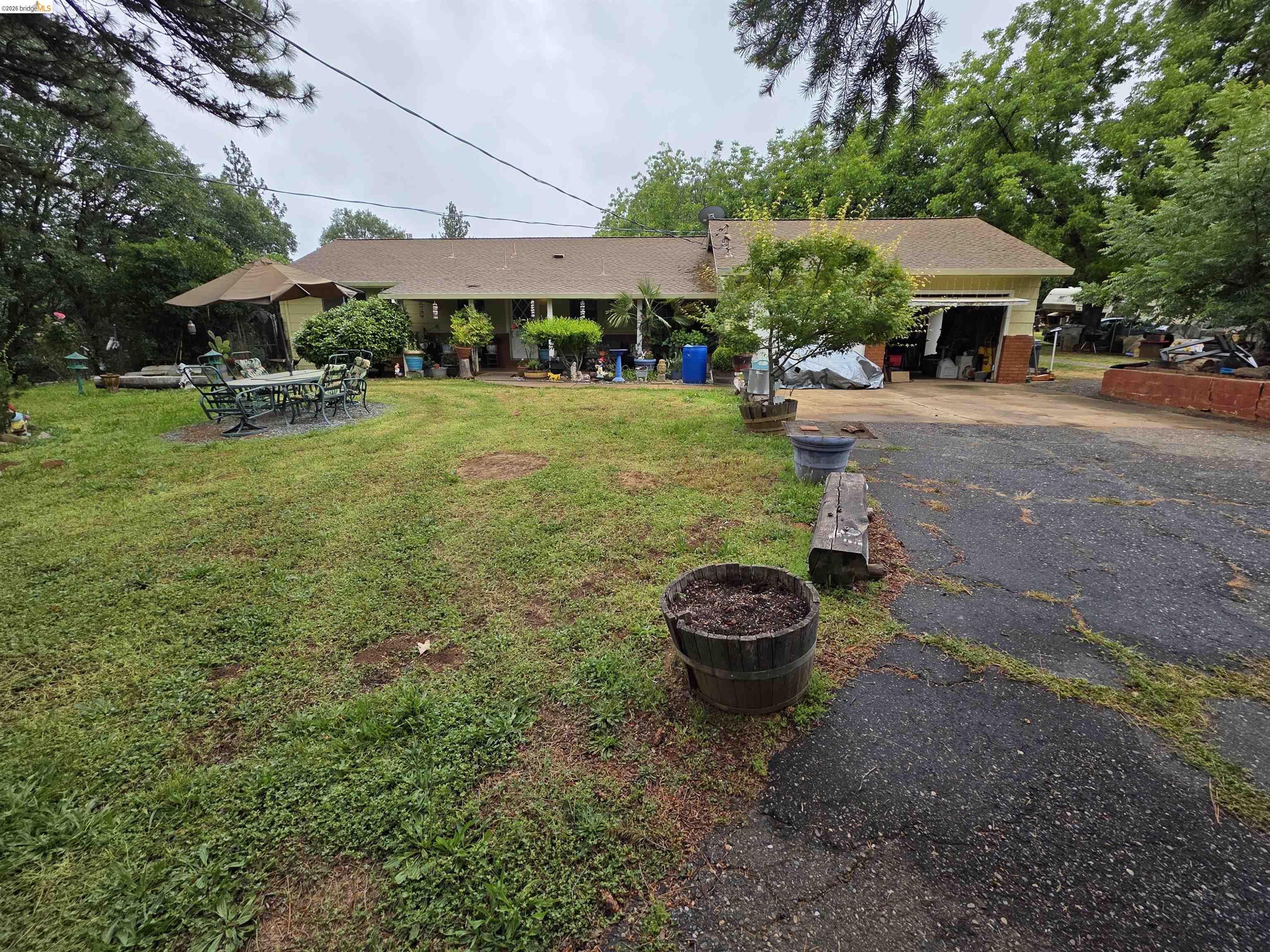 2323 Spink Road West Point, CA 95255 - Photo 2 of 17 Expansive front yard with a paved driveway and mature trees