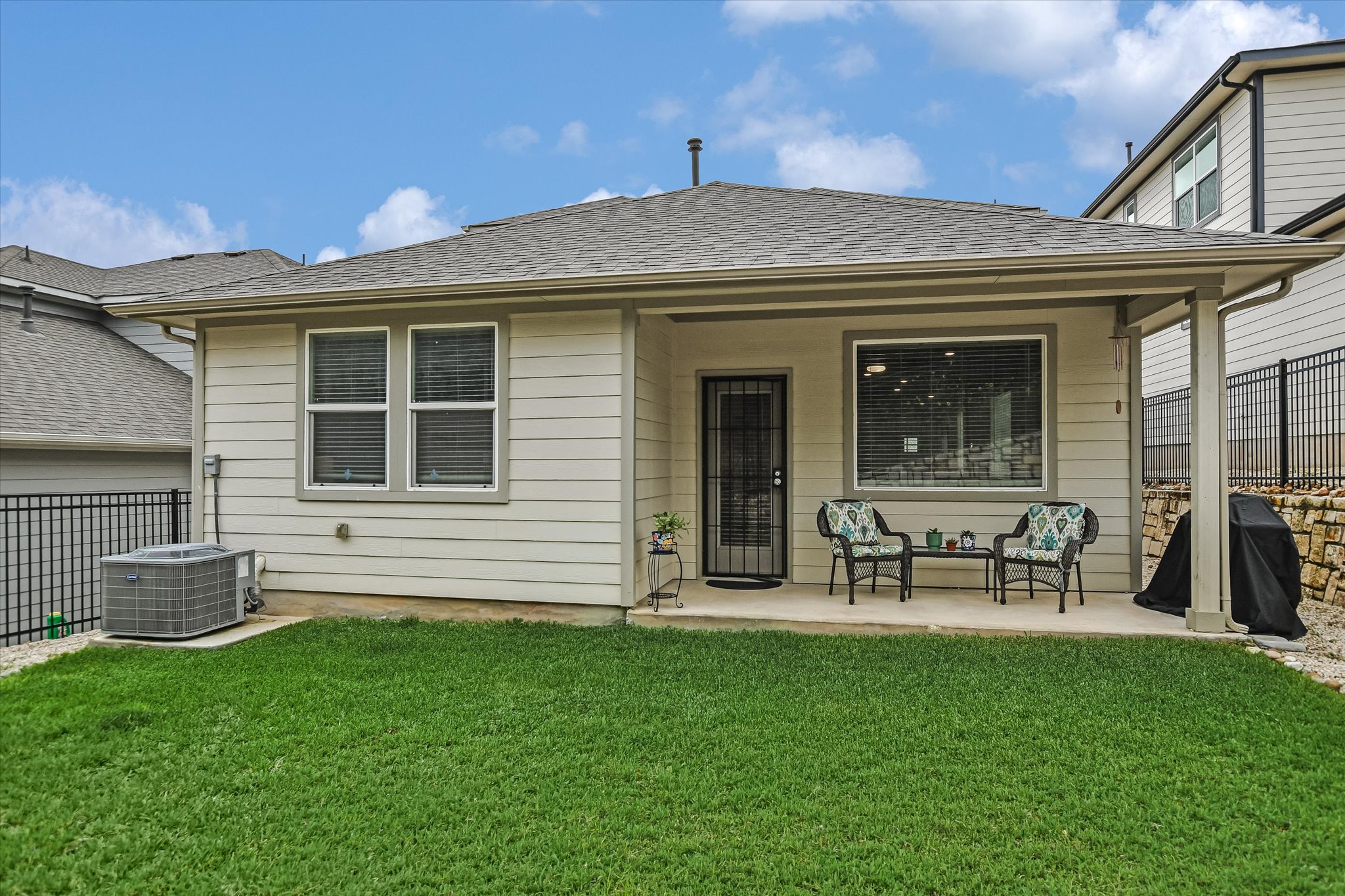 105 Merrick Road Georgetown, TX 78628 - Photo 19 of 23 A neatly manicured lawn extends from a comfortable covered patio, perfect for outdoor enjoyment.