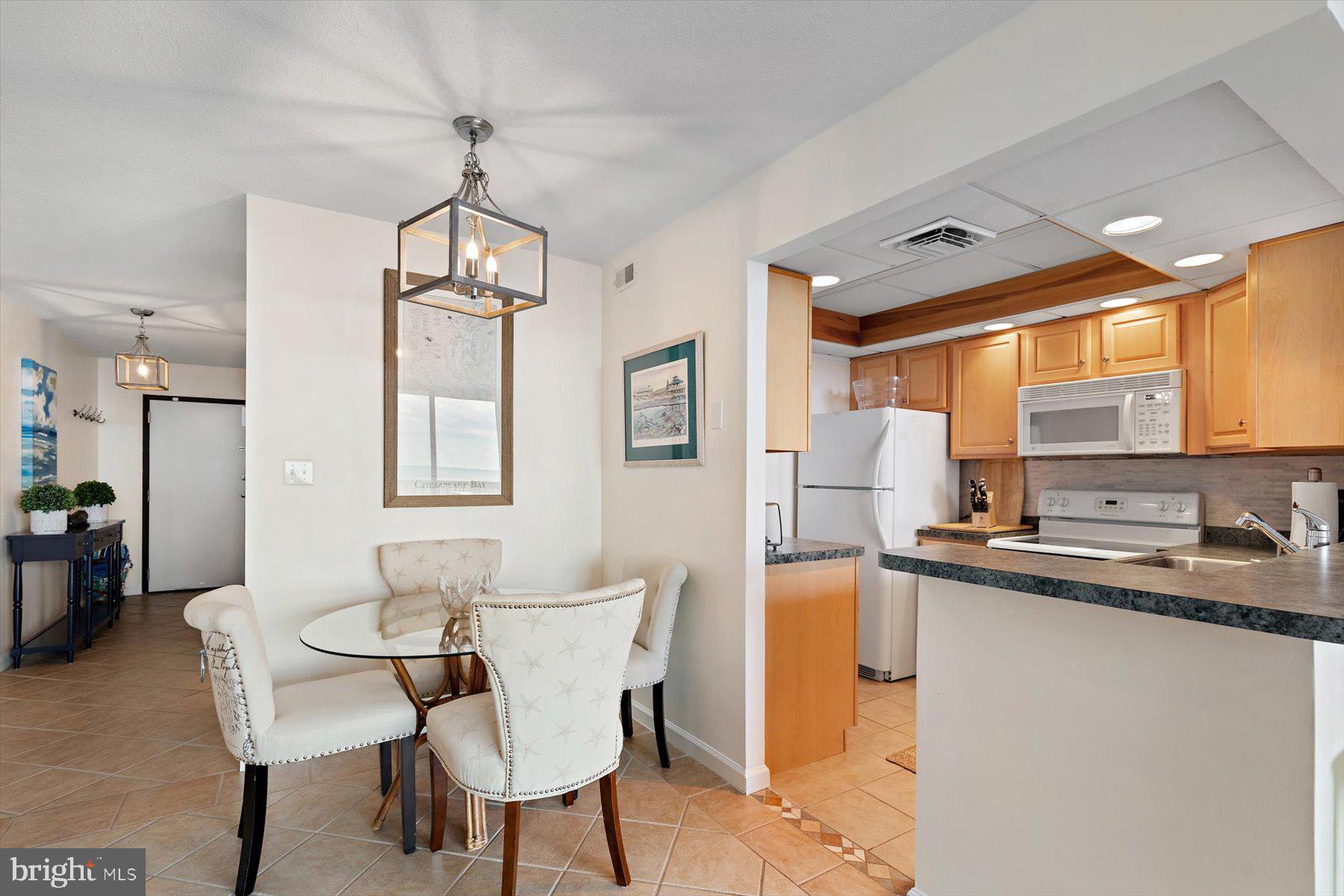 403 North Annapolis House Road Bethany Beach, DE 19930 - Photo 13 of 37 a dining room with stainless steel appliances a table and chairs
