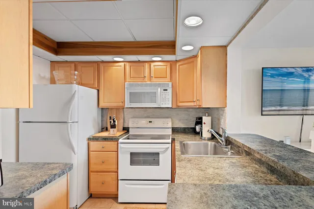 a kitchen with a stove a sink and a refrigerator
