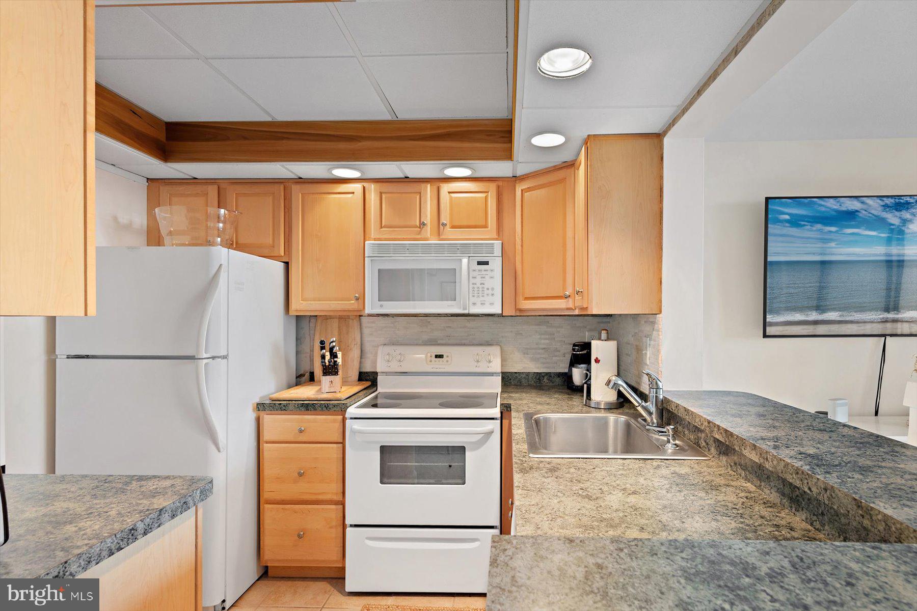 403 North Annapolis House Road Bethany Beach, DE 19930 - Photo 16 of 37 a kitchen with a stove a sink and a refrigerator