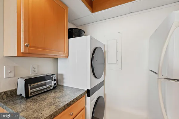 a view of a storage and utility room with washer and dryer