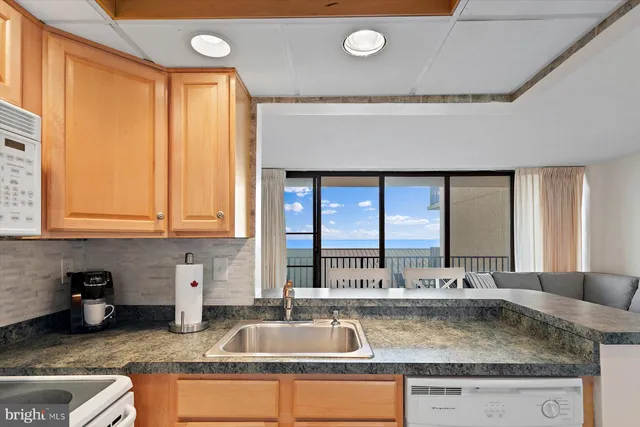 a kitchen with granite countertop a sink and a counter top space