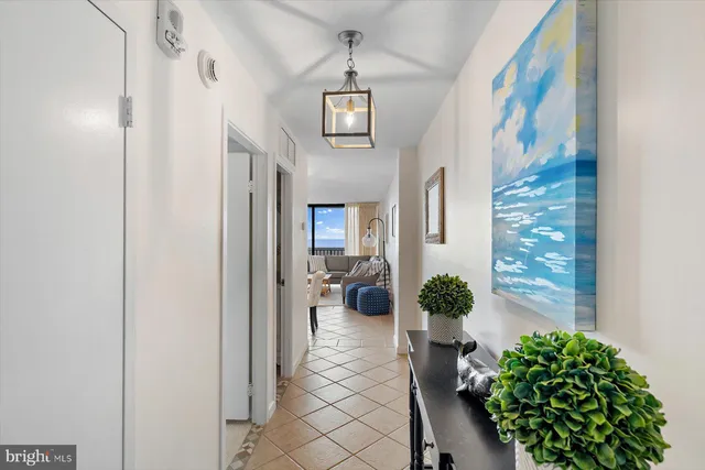 a view of a hallway with wooden floor and windows