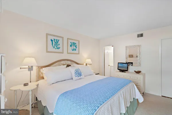a bedroom with a bed and a lamp