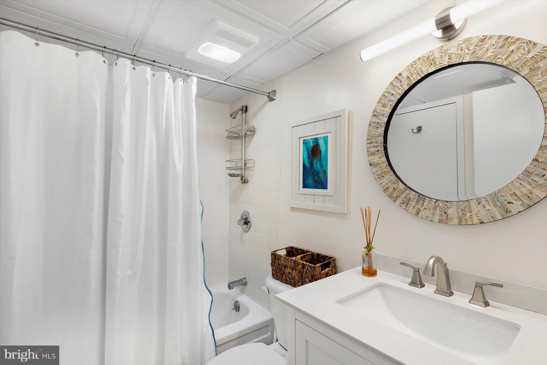 403 North Annapolis House Road Bethany Beach, DE 19930 - Photo 26 of 37 a bathroom with a sink and a mirror