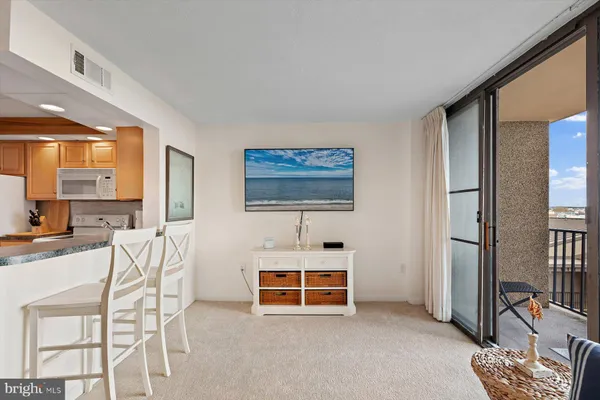 a living room with furniture a window and a flat screen tv