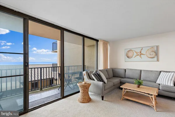 a living room with furniture city view and large windows