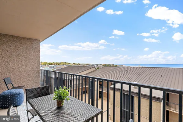 a balcony with wooden floor and city view