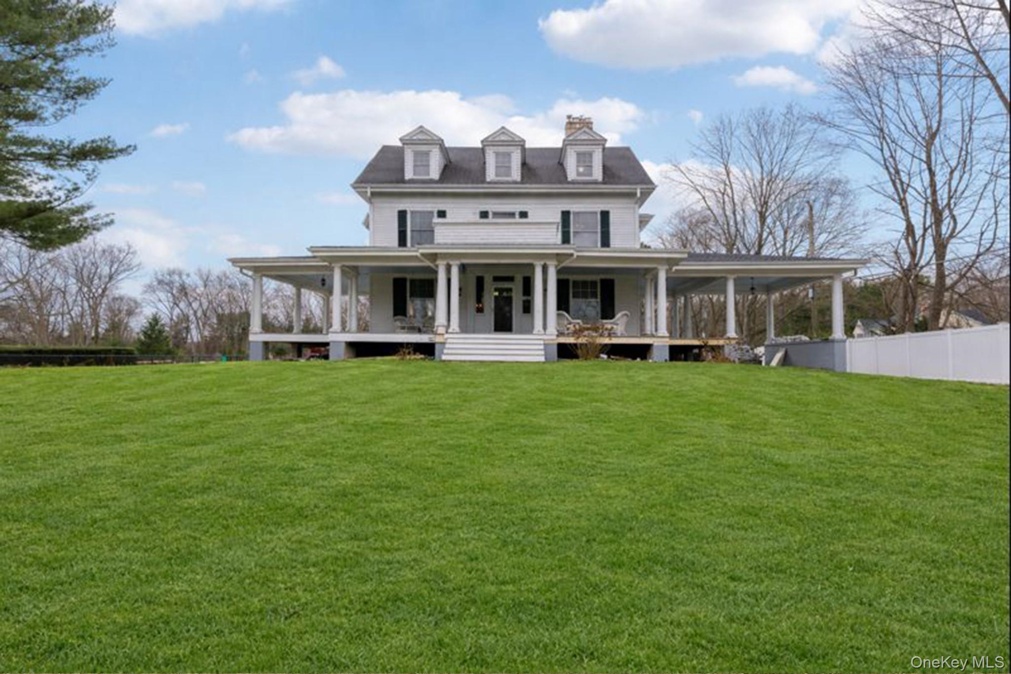 a view of a house with a yard and sitting space
