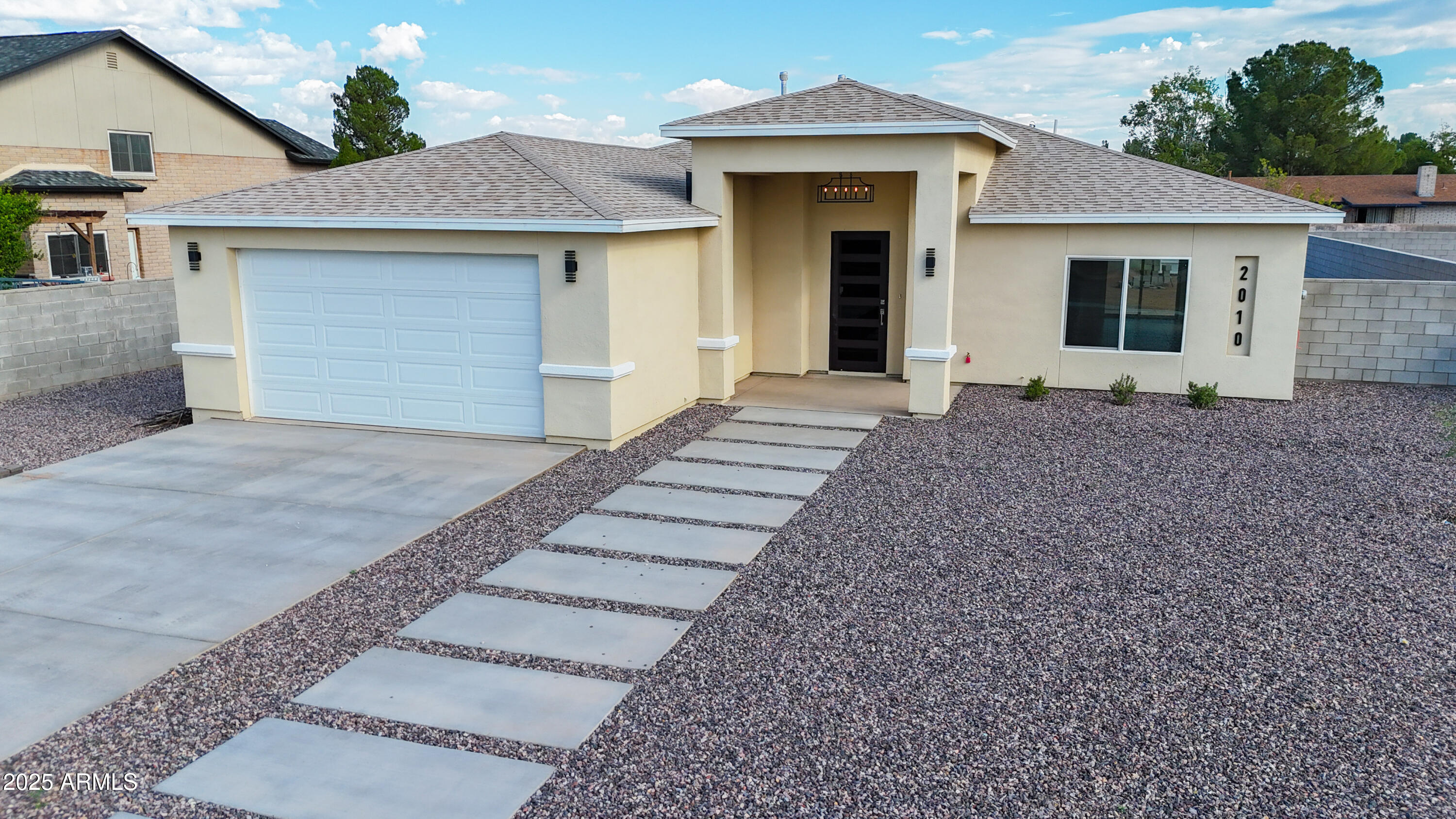 2010 East 13th Street Douglas, AZ 85607 - Photo 11 of 53 a front view of a house with a yard and garage