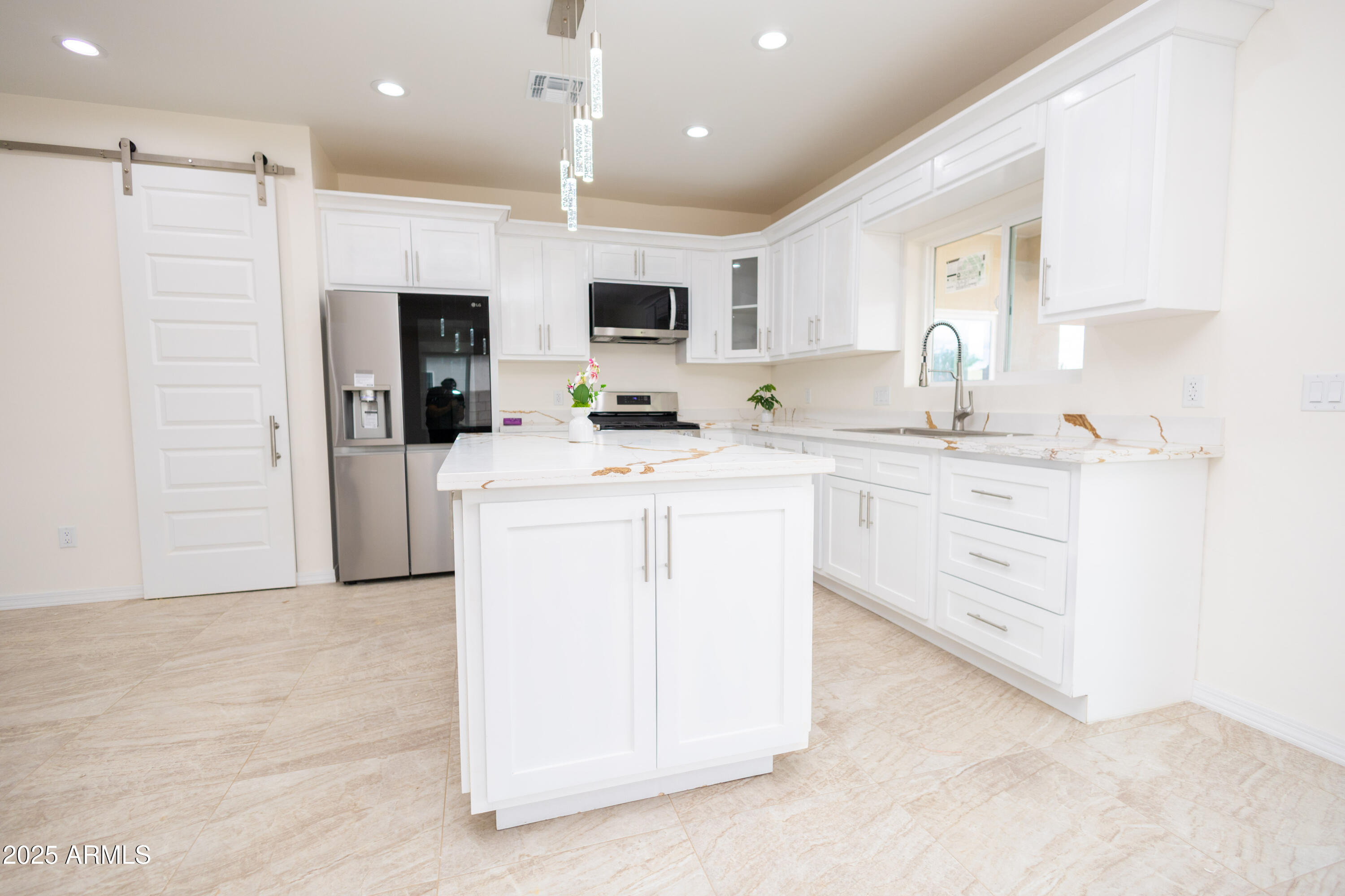 2010 East 13th Street Douglas, AZ 85607 - Photo 15 of 53 a kitchen with a sink a counter top space stainless steel appliances and cabinets