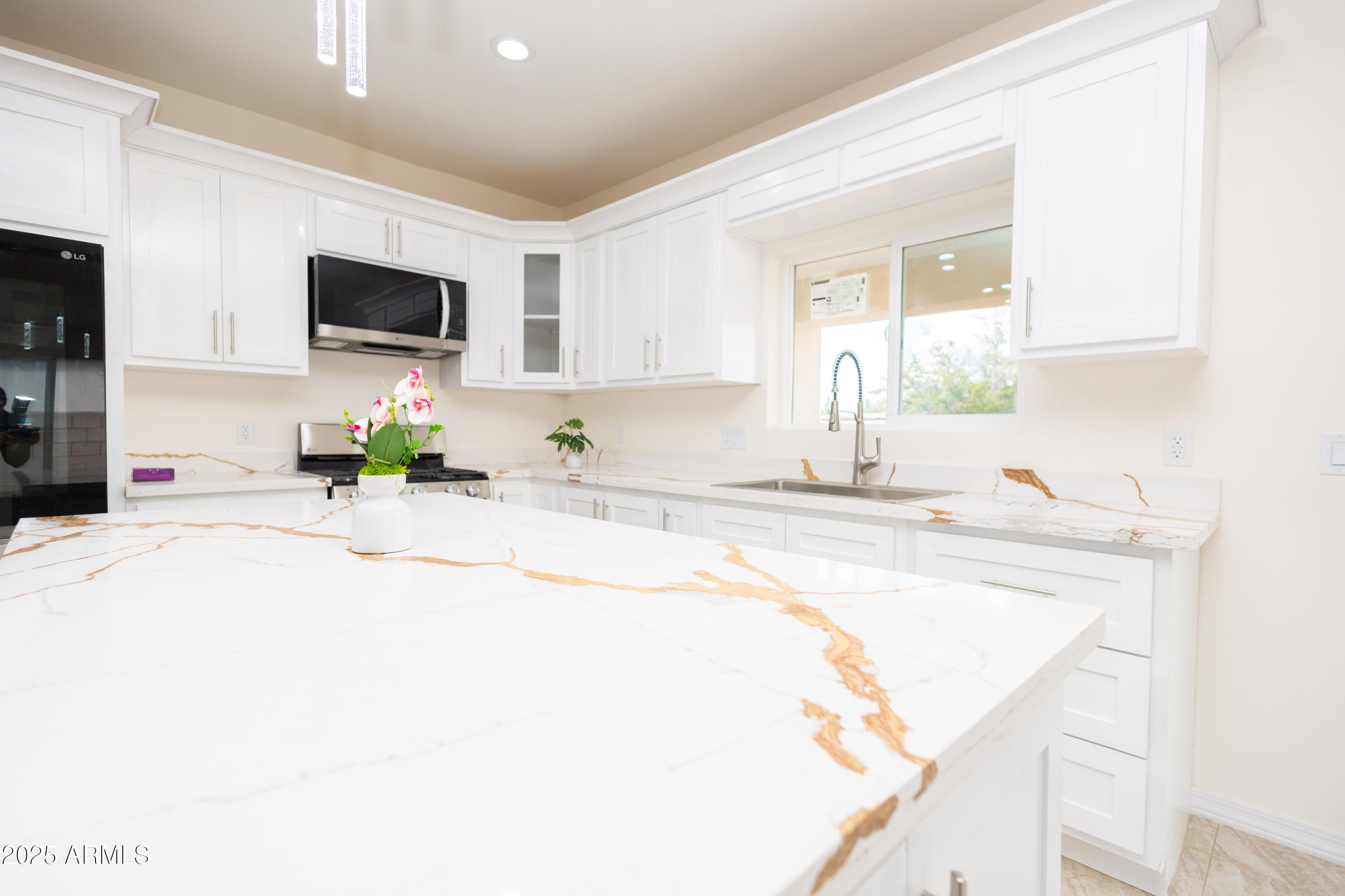 2010 East 13th Street Douglas, AZ 85607 - Photo 16 of 53 a kitchen with stainless steel appliances a sink a stove a microwave a sink and cabinets