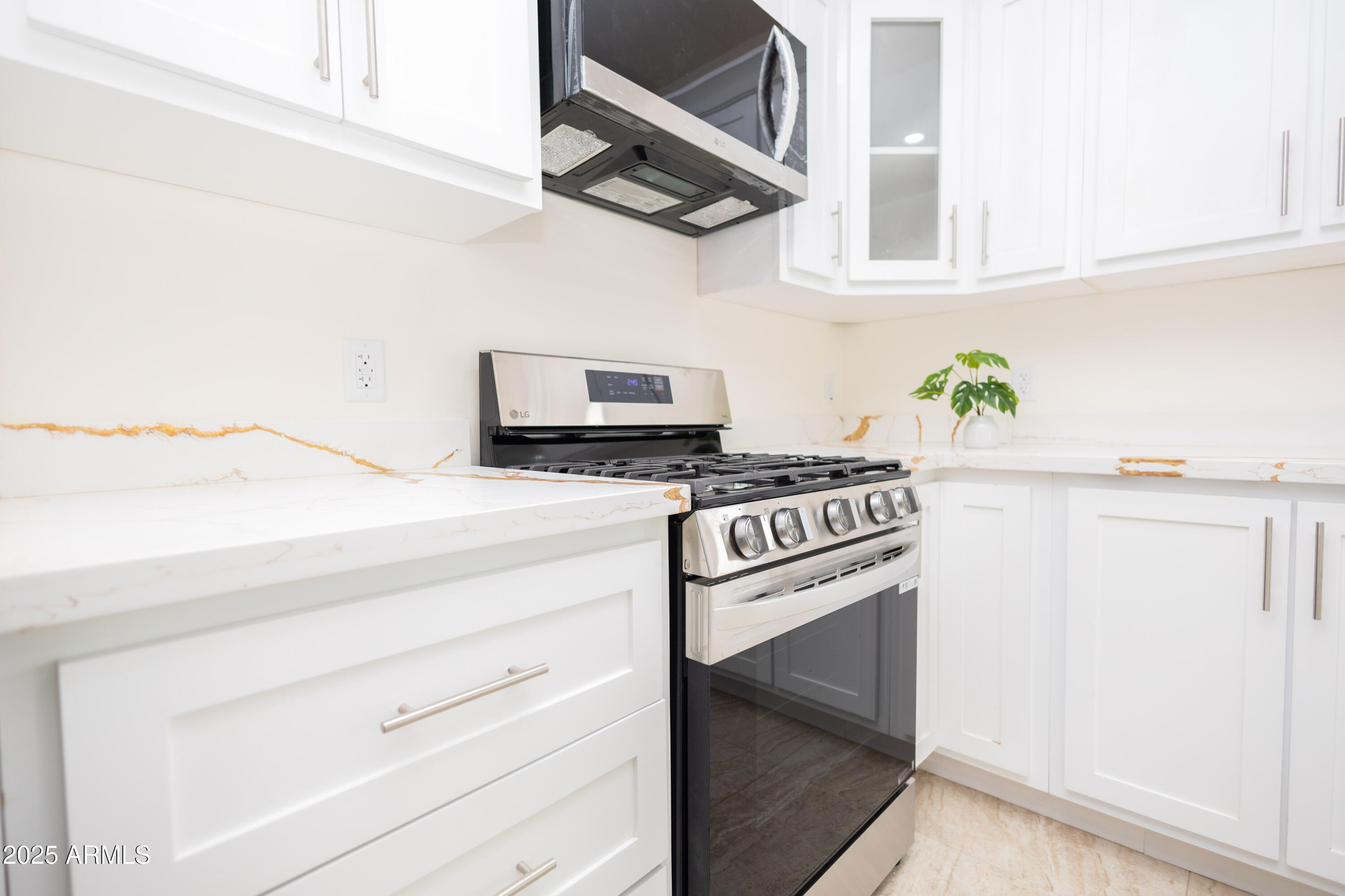 2010 East 13th Street Douglas, AZ 85607 - Photo 21 of 53 a kitchen with white cabinets and appliances