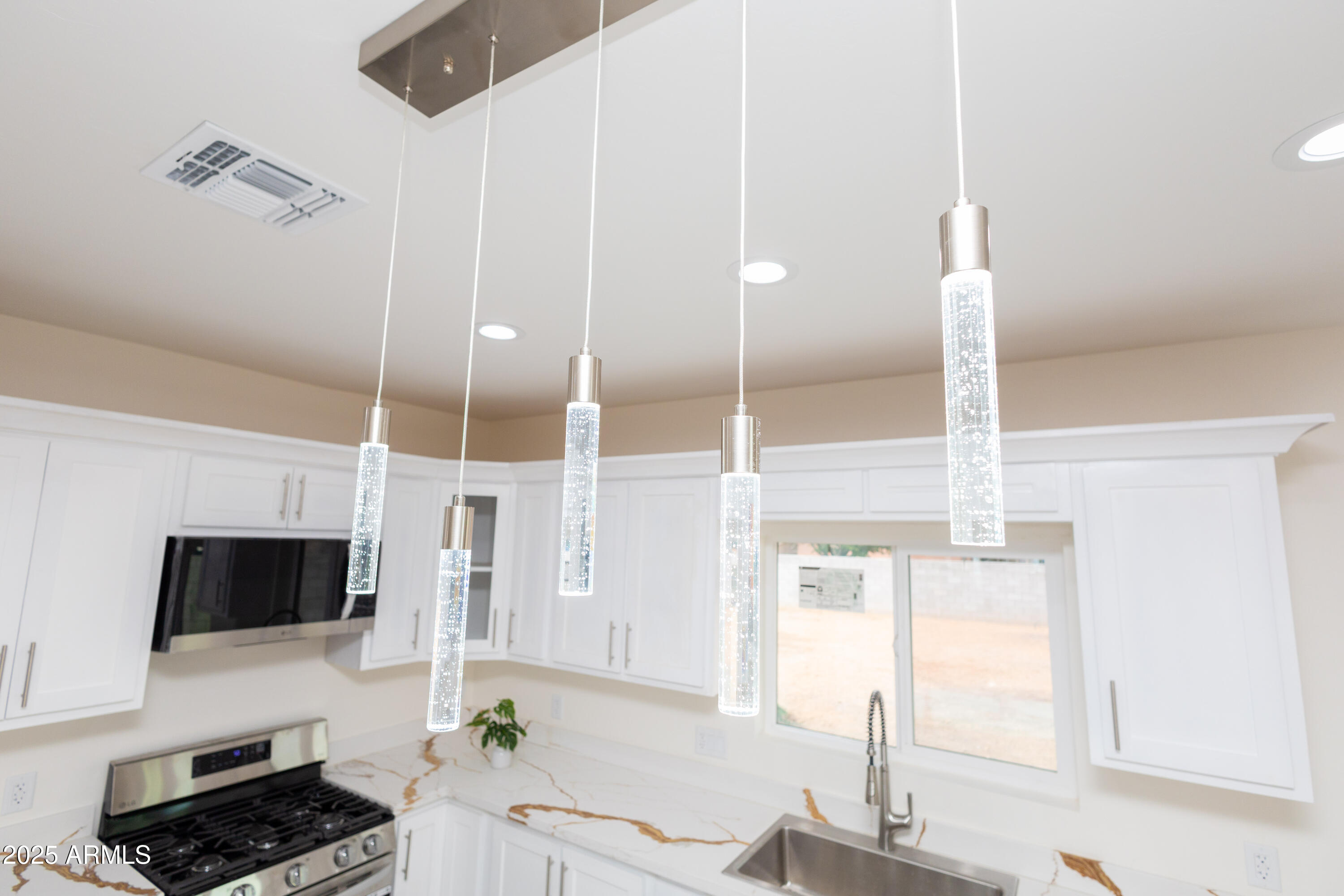 2010 East 13th Street Douglas, AZ 85607 - Photo 24 of 53 a kitchen with stainless steel appliances kitchen island granite countertop a sink and cabinets