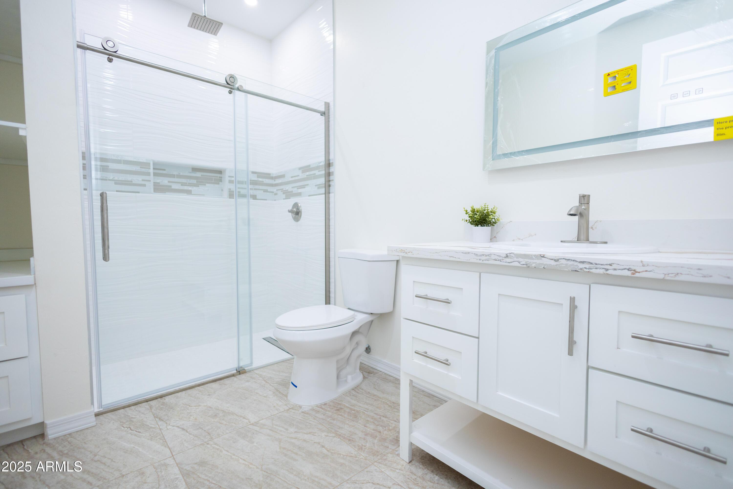 2010 East 13th Street Douglas, AZ 85607 - Photo 34 of 53 a bathroom with a granite countertop sink a toilet and a mirror