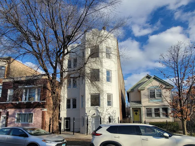 a front view of a residential apartment building with a yard
