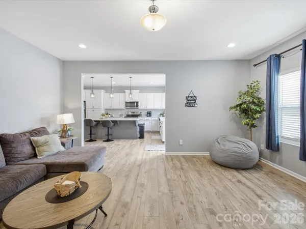 a living room with furniture and kitchen view