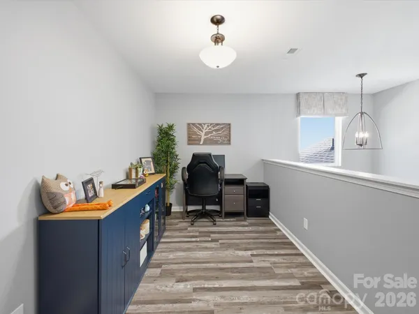 a living room with furniture gym equipment and a window