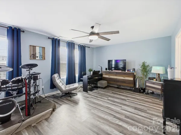 a bedroom with furniture and a flat screen tv