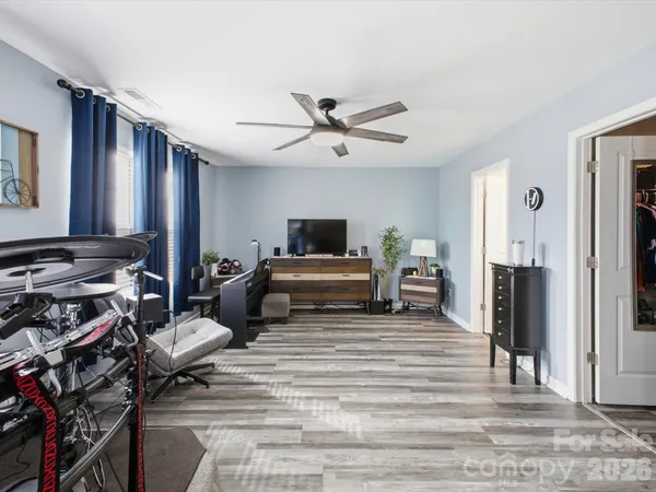 a living room with furniture and wooden floor