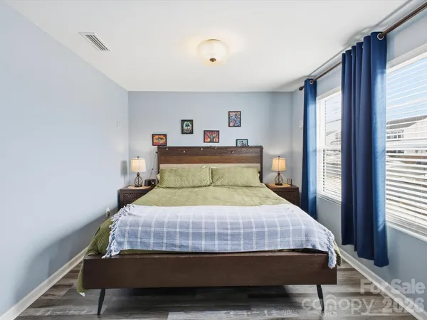 a bed sitting in a bedroom next to a window