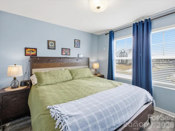 a bedroom with a bed and a large window