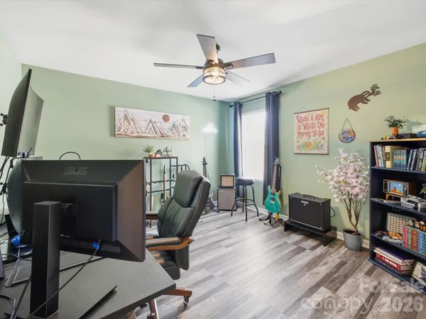 a view of a workspace with furniture and wooden floor