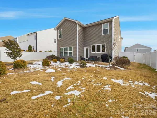 a view of a house with swimming pool and sitting area