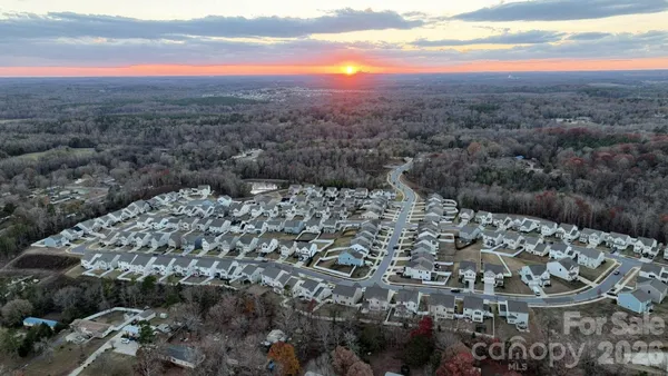 a front view of a multi story building with yard