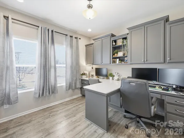 a kitchen with a refrigerator and a stove top oven