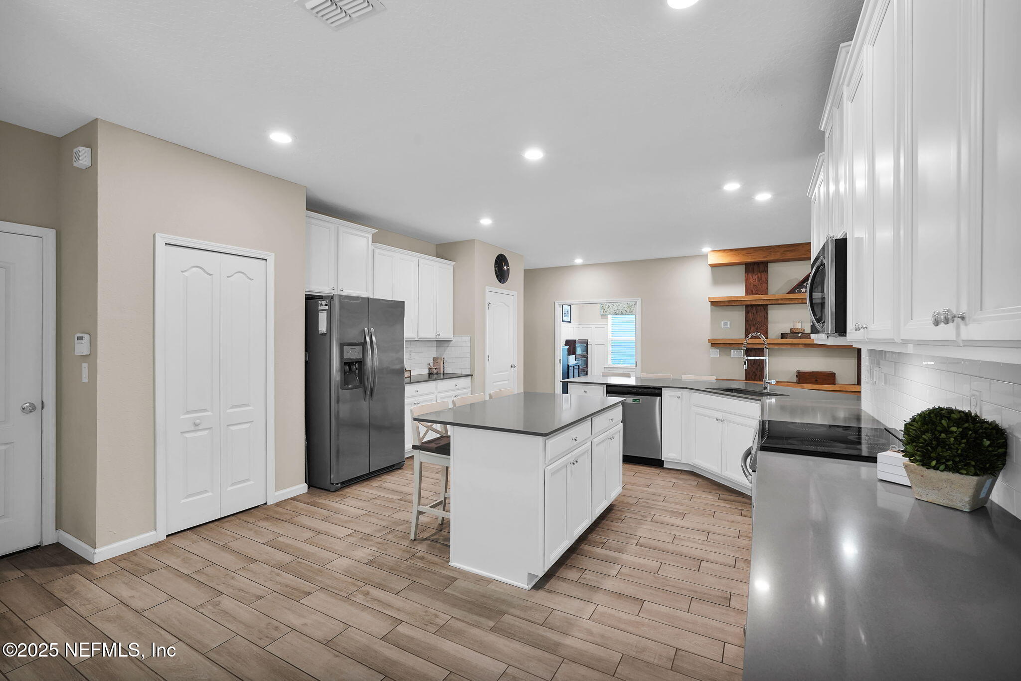 44 Athens Drive St. Augustine, FL 32092 - Photo 13 of 46 a kitchen with white cabinets and stainless steel appliances