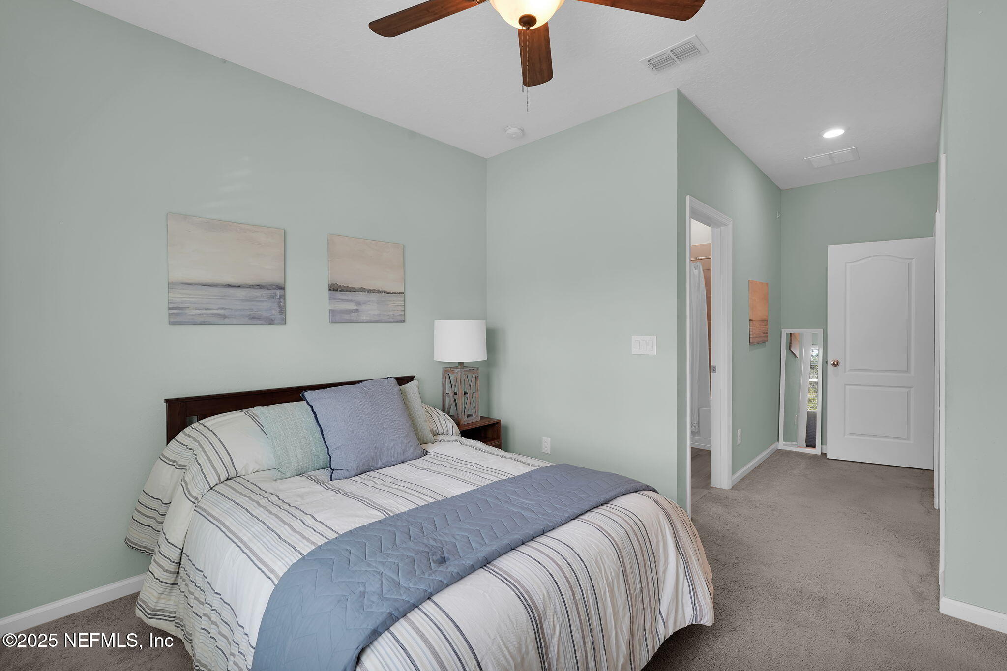 44 Athens Drive St. Augustine, FL 32092 - Photo 24 of 46 a bedroom with a bed and a chandelier