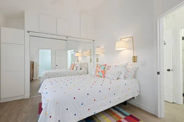 a bedroom with a bed and wooden floor