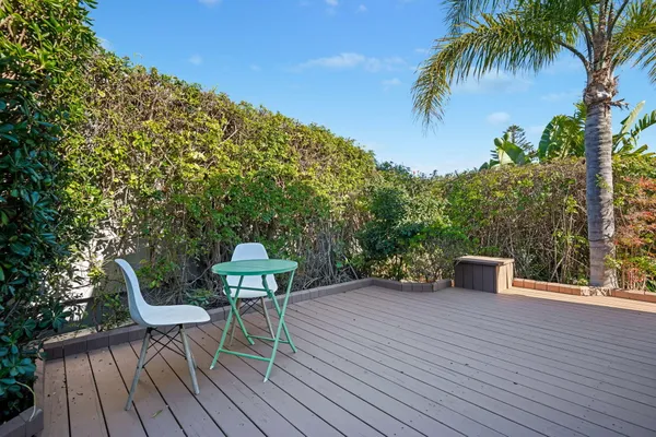 a view of a chairs and table on the wooden deck