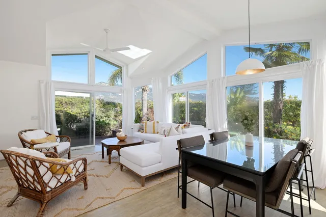 a living room with furniture and a floor to ceiling window