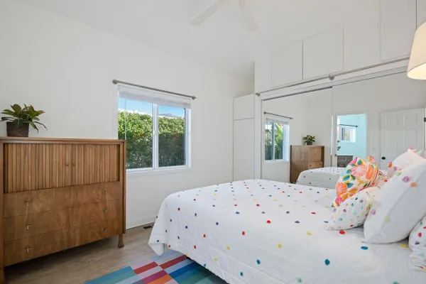 a bedroom with a bed and wooden floor