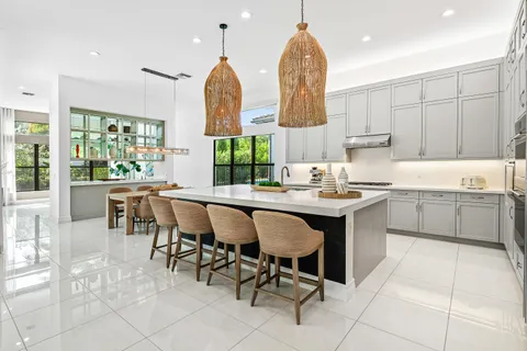a dining room with furniture a chandelier and a rug